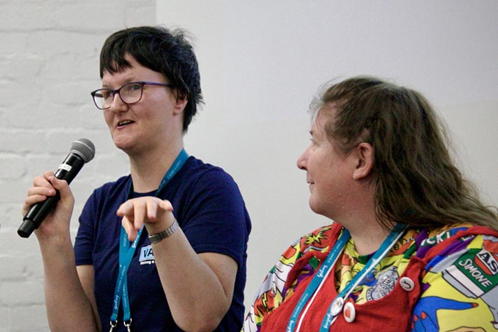 Woman with disability holding microphone and talking